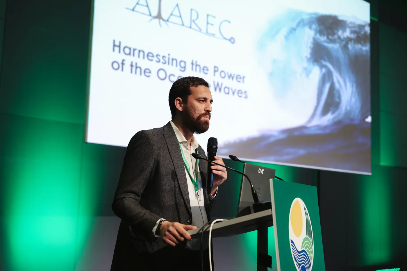 A speaker pitches an ocean wave-energy solution at the GSIS 2026 podium during the Blue Economy track of the Solutions Showcase, Gran Canaria