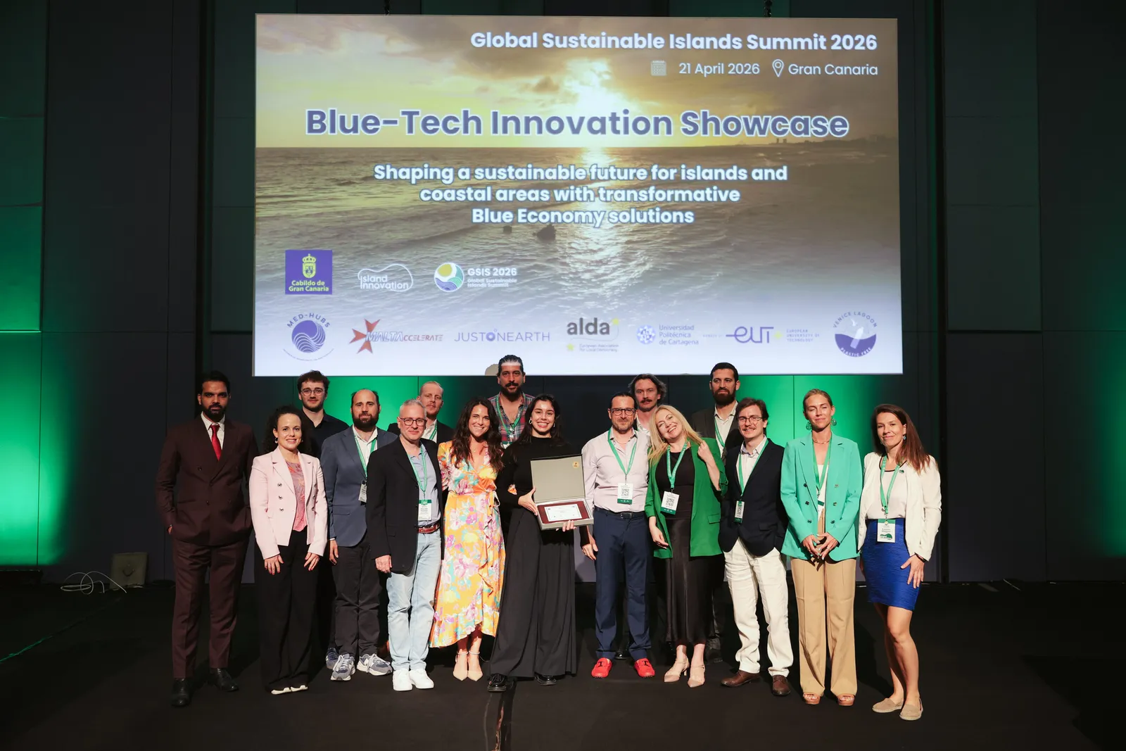 The full cohort of innovators and organisers gather on stage under the Global Sustainable Islands Summit 2026 Blue-Tech Innovation Showcase title screen, Gran Canaria