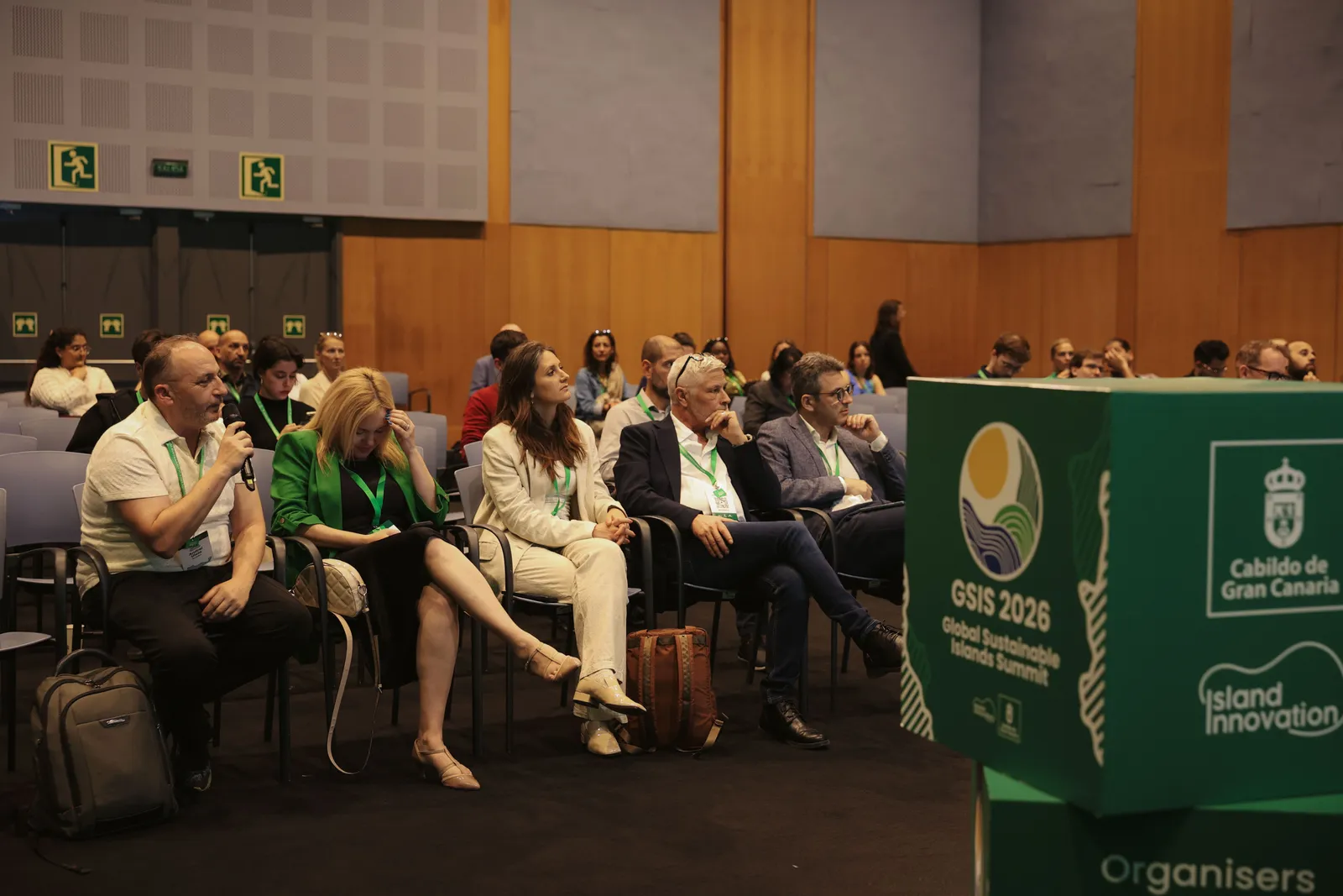 Attendees wearing green GSIS lanyards listen as a participant asks a question during the Solutions Showcase at GSIS 2026, Gran Canaria