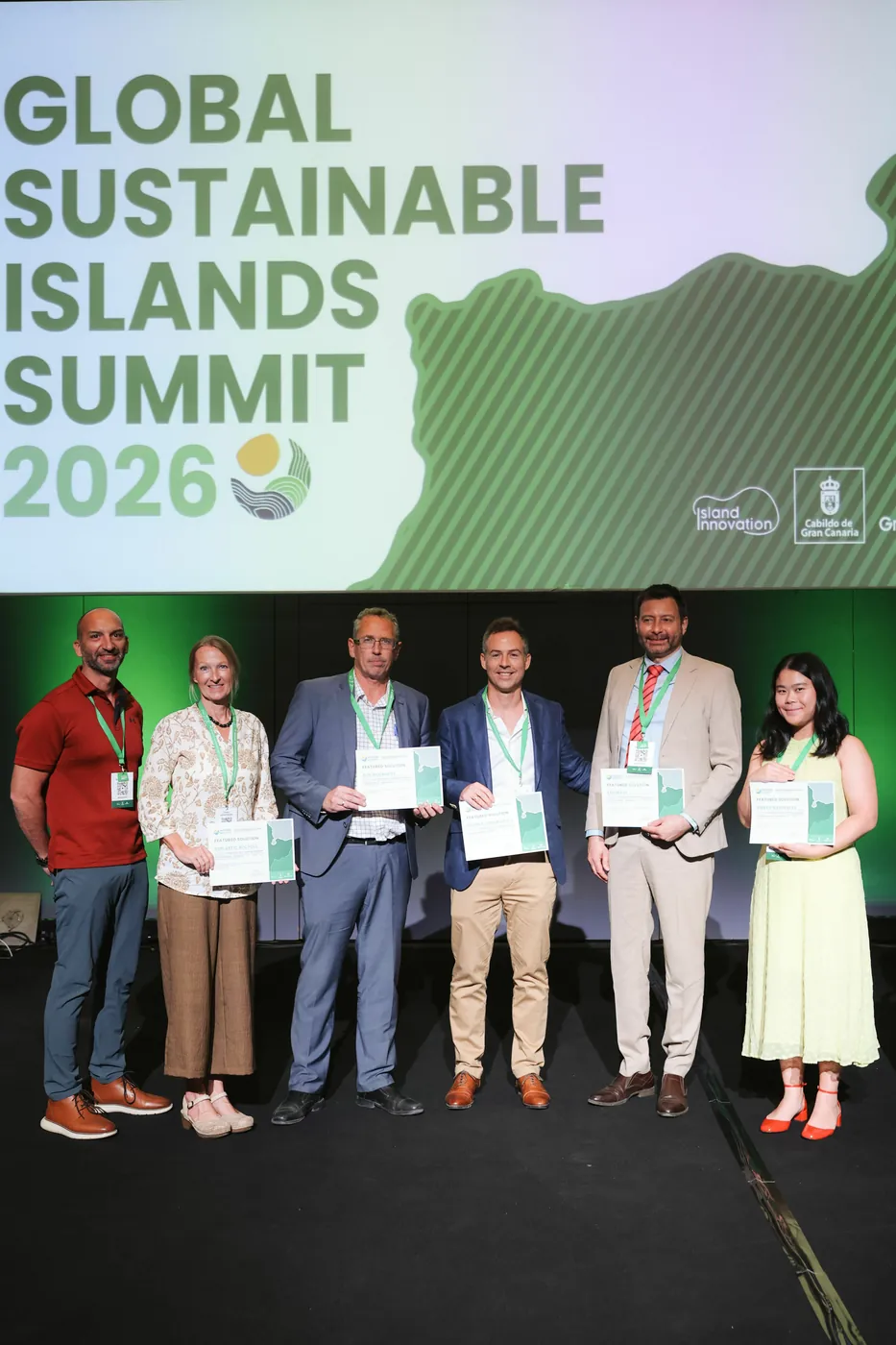 Featured Solution honourees stand together on stage holding their certificates in front of the Global Sustainable Islands Summit 2026 screen, with the Island Innovation and Cabildo de Gran Canaria logos, Gran Canaria